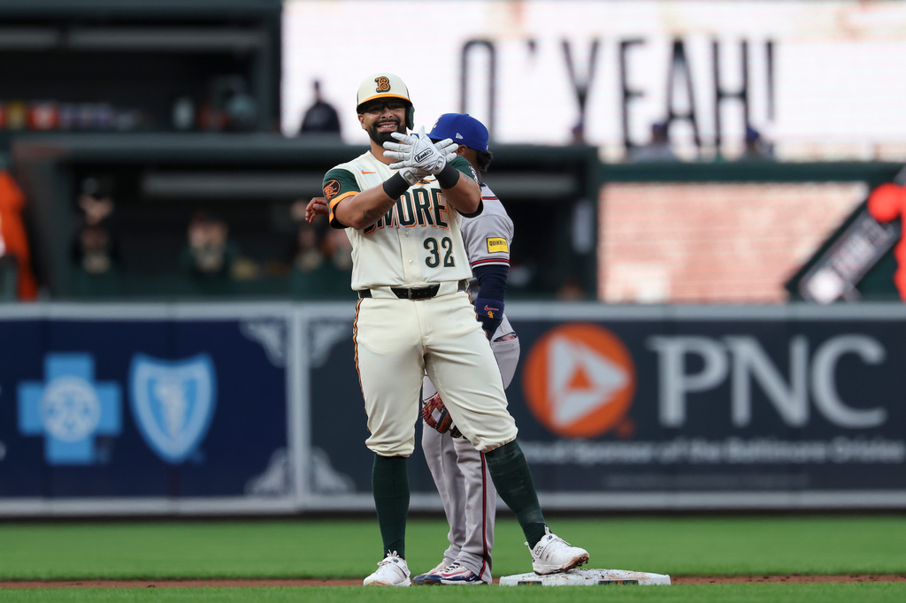 Baltimore Orioles' Christian Encarnacion-Strand (32) gestures toward his dugout after hitting a double off Atlanta Braves pitcher Grant Holmes which scored Leody Taveras and Jackson Holliday during the second inning of a baseball game, Friday, July 24, 2026, in Baltimore. (AP Photo/Terrance Williams)