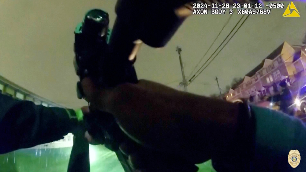 In this image from police body camera video provided by the Akron, Ohio Police Department, officers display their weapons as they confront 15-year-old boy Jazmir Tucker in Akron, Ohio, late Nov. 28, 2024. (Akron Police Department via AP)