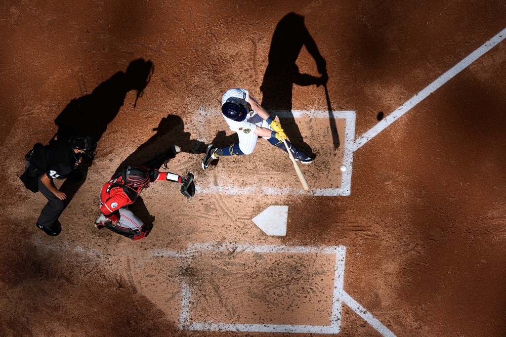 Milwaukee Brewers' Andrew Vaughn hits an RBI double during the fourth inning of a baseball game against the Cincinnati Reds Sunday, Sept. 28, 2025, in Milwaukee. (AP Photo/Morry Gash)