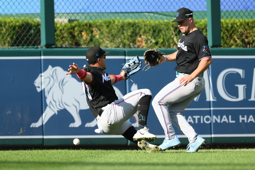 Miami Marlins left fielder Heriberto Hernández, left, and center fielder Jakob Marsee, right, cannot catch a ball that went for a double hit by Washington Nationals' Jorbit Vivas during the third inning of a baseball game, Saturday, Aug. 29, 2026, in Washington. (AP Photo/Nick Wass)
