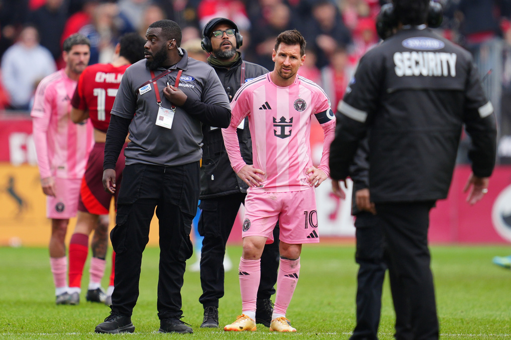 Inter Miami CF midfielder Lionel Messi (10) is surrounded by security on the field after multiple fans ran onto the pitch during second half MLS soccer against Toronto FC, in Toronto on Saturday, May 9, 2026. (Frank Gunn /The Canadian Press via AP)
