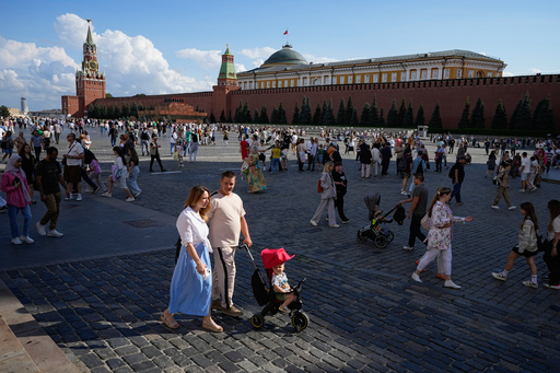 FILE - A family walks through Red Square in Moscow, Russia, Sunday, Aug. 4, 2024. (AP Photo/Alexander Zemlianichenko, File) FILE - A family walks through Red Square in Moscow, Russia, Sunday, Aug. 4, 2024. (AP Photo/Alexander Zemlianichenko, File)