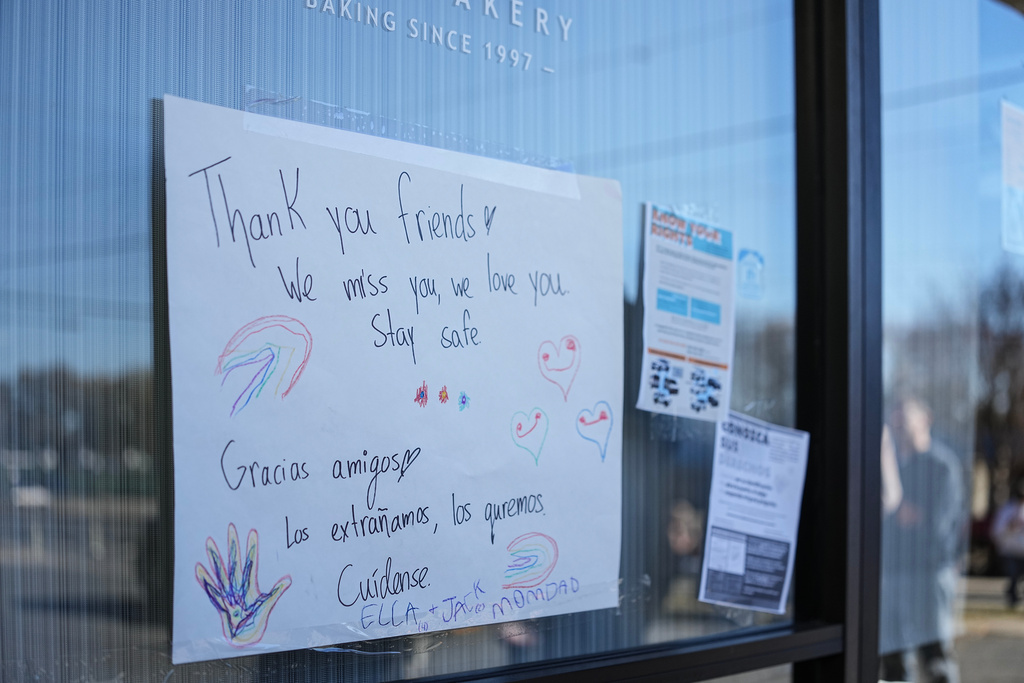 A sign of support is posted outside of Manolo's bakery which is closed amidst federal law enforcement presence, Monday, Nov. 17, 2025, in Charlotte, N.C. (AP Photo/Matt Kelley)
