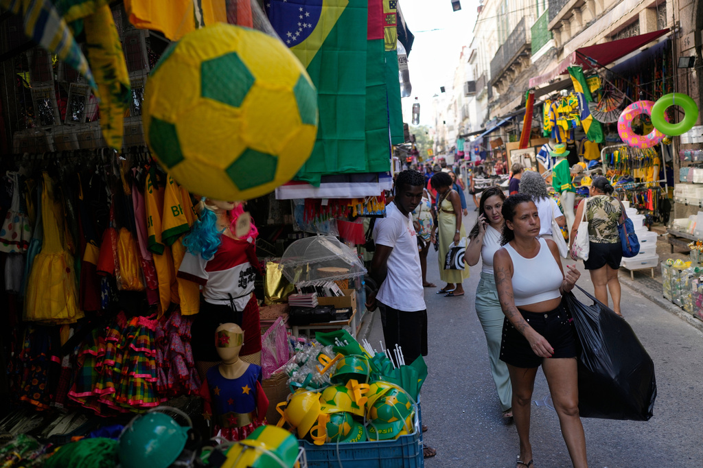 Shoppers walk through the Saara street market in Rio de Janeiro, Thursday, April 26, 2026. (AP Photo/Silvia Izquierdo)