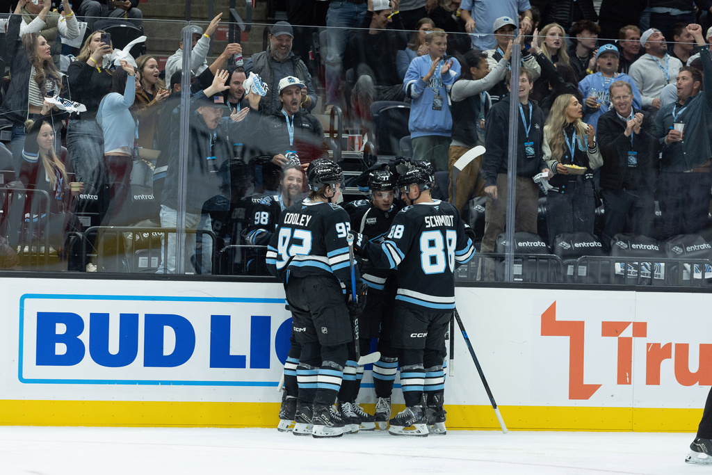 Utah Mammoth Celebrate the goal against the Calgary Flames during the second half of an NHL hockey game Wednesday, Oct. 15, 2025, in Salt Lake City. (AP Photo/Melissa Majchrzak)