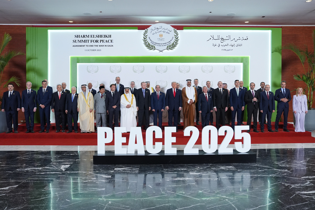 President Donald Trump and other world leaders pose for a photo during a summit to support ending the more than two-year Israel-Hamas war in Gaza after a breakthrough ceasefire deal, Monday, Oct. 13, 2025, in Sharm El Sheikh, Egypt. (AP Photo/Evan Vucci, Pool)