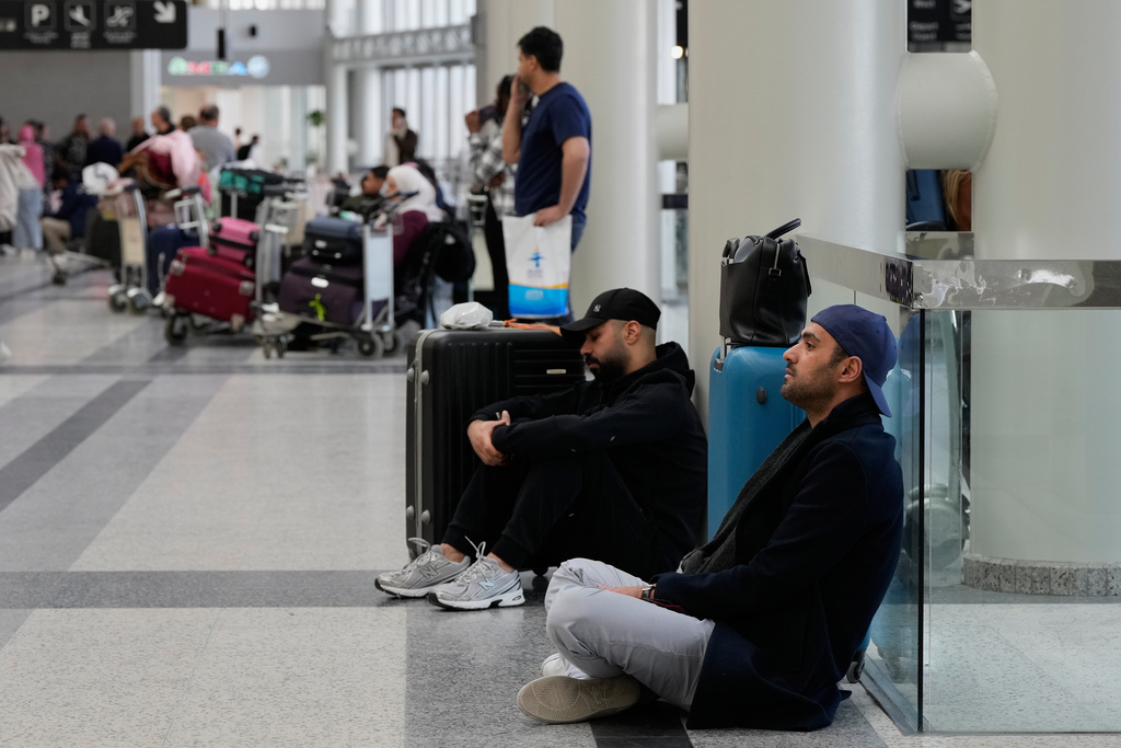 Passengers whose flights were cancelled, wait at the departure terminal of Rafik Hariri International Airport in Beirut, Lebanon, Saturday, Feb. 28, 2026, as many airlines canceled flights due to the conflict involving the United States, Israel and Iran. (AP Photo/Hassan Ammar)