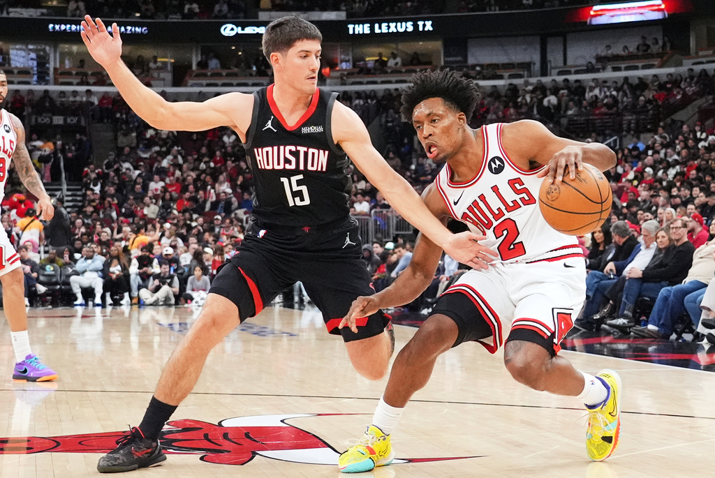 Chicago Bulls guard Collin Sexton (2) drives as Houston Rockets guard Reed Sheppard (15) guards during the first half of an NBA basketball game in Chicago, Monday, March 23, 2026. (AP Photo/Nam Y. Huh)