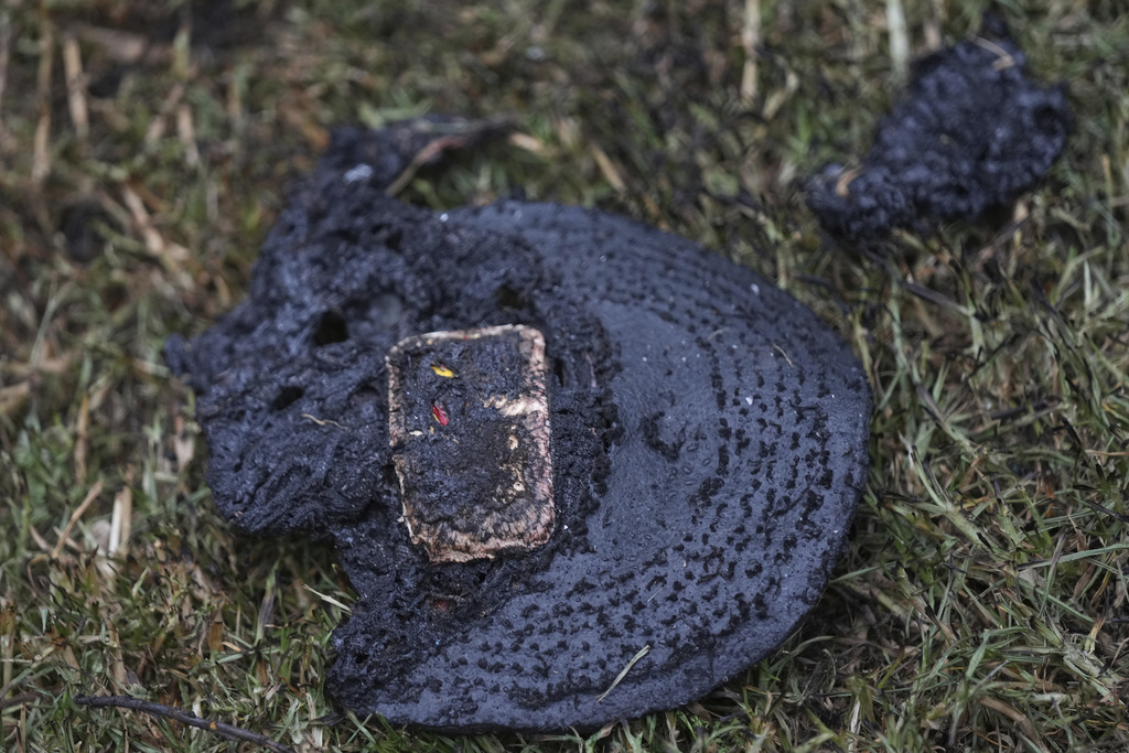 A burned hat sits on the grass after a gas tanker exploded in Mexico City, Wednesday, Sept. 10, 2025. (AP Photo/Fernando Llano)