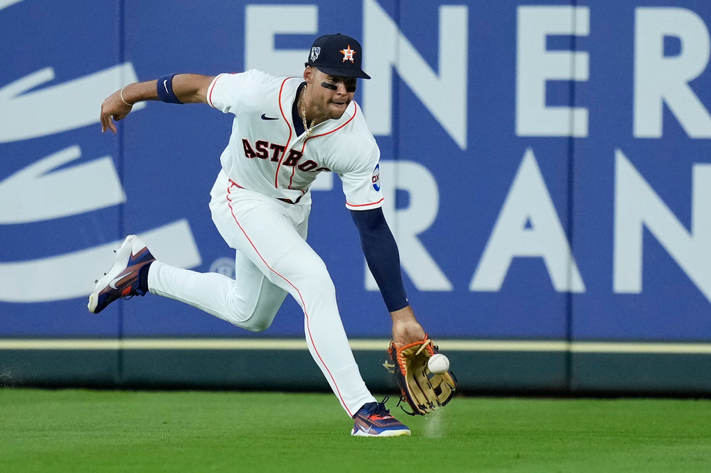 Houston Astros right fielder Cam Smith fields a base hit by Colorado Rockies' Mickey Moniak during the first inning of a baseball game Wednesday, April 15, 2026, in Houston. (AP Photo/Kevin M. Cox)