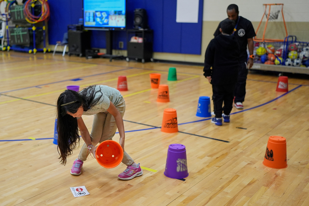 Magaly Perez participates in a gun safety lesson at Berclair Elementary School, Monday, Oct. 27, 2025, in Memphis, Tenn. (AP Photo/George Walker IV)