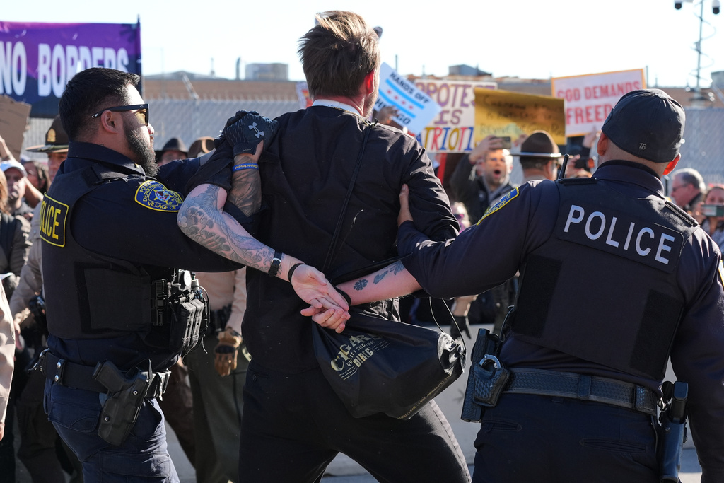 Broadview Police detain a protester outside an ICE processing facility in the Chicago suburb of Broadview, Ill., Friday, Nov. 14, 2025. (AP Photo/Nam Y. Huh)