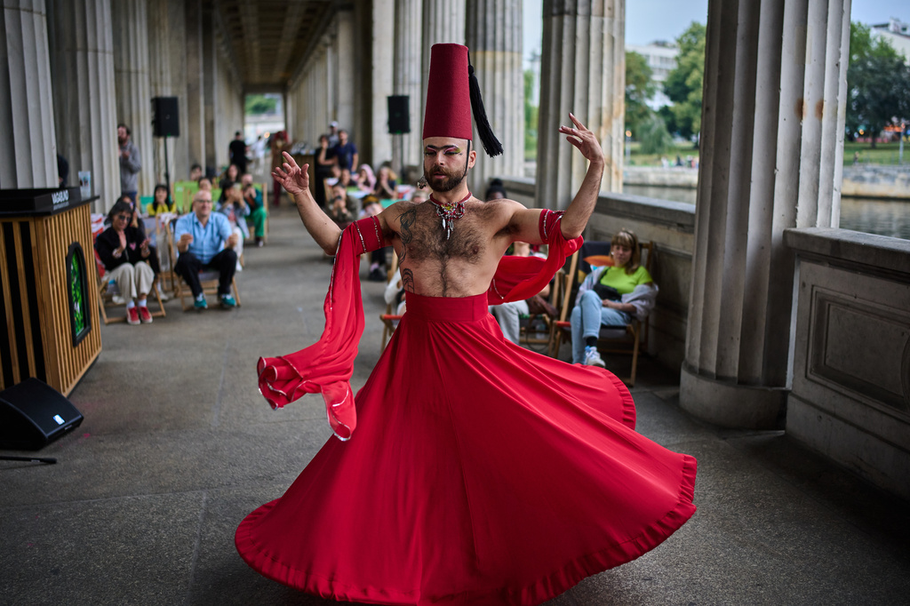 Haidar Darwish, a Syrian belly dancer with the Berlin-based LGBTQ collective Queens Against Borders, performs during an open-air show in Berlin, Germany, Sunday, July 26, 2026. (AP Photo/Ebrahim Noroozi)