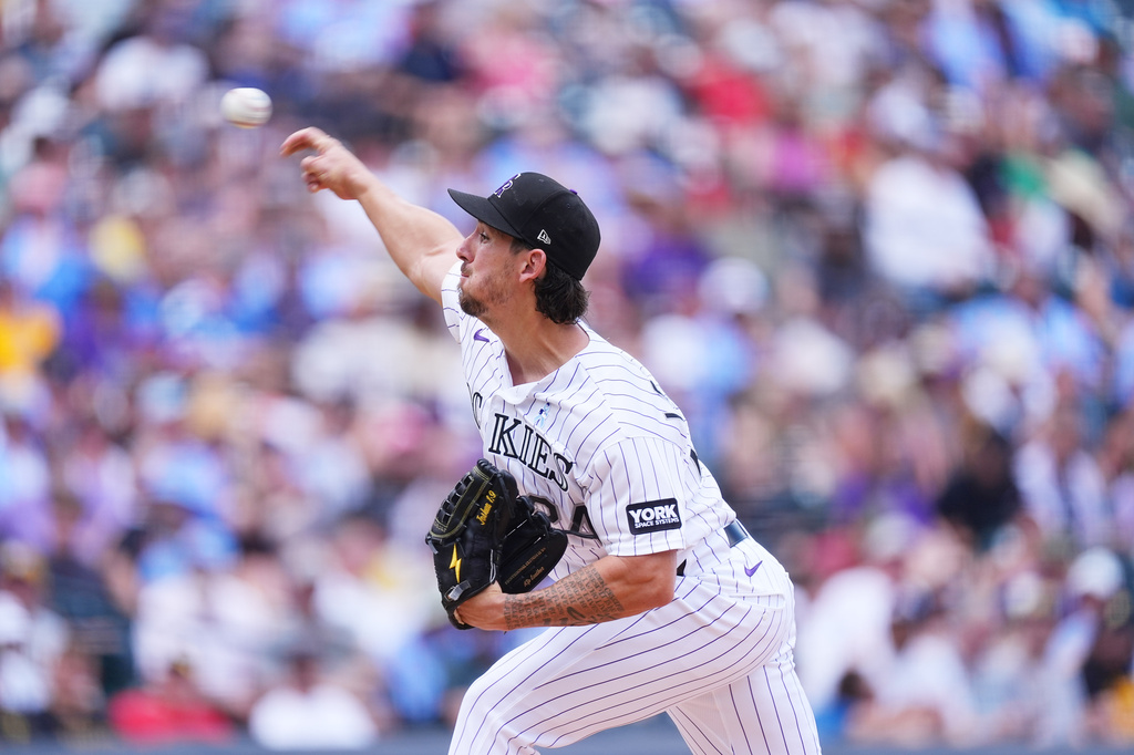 Colorado Rockies starting pitcher Michael Lorenzen works against the Pittsburgh Pirates in the first inning of a baseball game Sunday, June 21, 2026, in Denver. (AP Photo/David Zalubowski)
