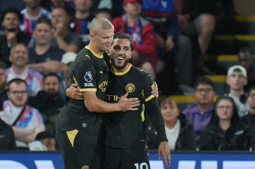 Manchester City's Rayan Cherki, right, celebrates with Erling Haaland after scoring his side's third goal during the English Premier League soccer match between Crystal Palace and Manchester City in London, Friday, Aug. 28, 2026. (AP Photo/Kin Cheung)