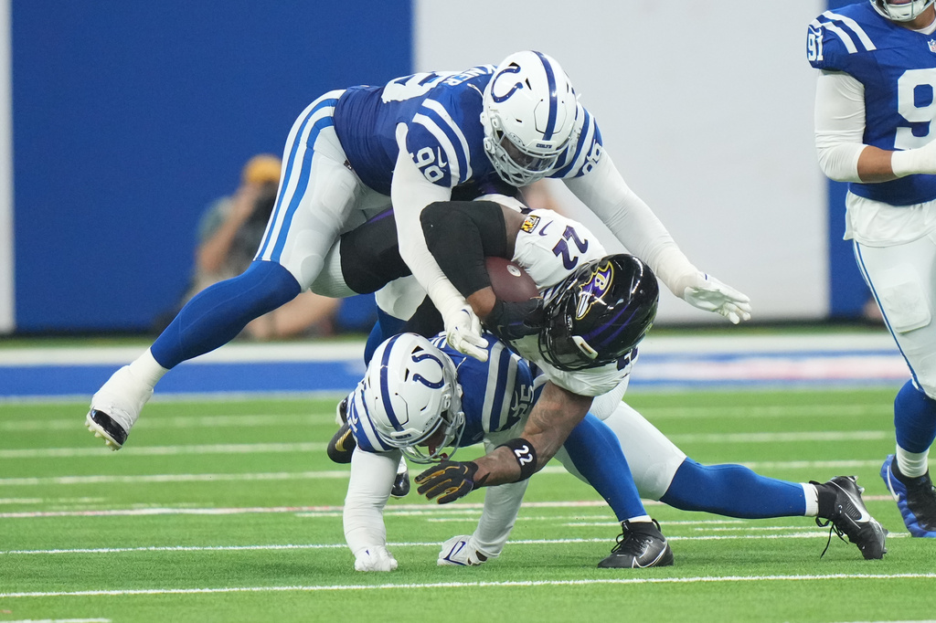 Baltimore Ravens' Derrick Henry is stopped by Indianapolis Colts' DeForest Buckner and A.J. Haulcy during the second half of an NFL football game Sunday, Sept. 13, 2026, in Indianapolis. (AP Photo/AJ Mast)