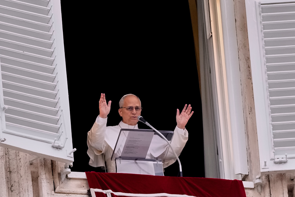 Pope Leo XIV appears at his studio window to deliver the traditional Sunday blessing to faithful and pilgrims gathered in St. Peter's Square at the Vatican for the noon Angelus prayer, Sunday, Feb. 8, 2026. (AP Photo/Gregorio Borgia)