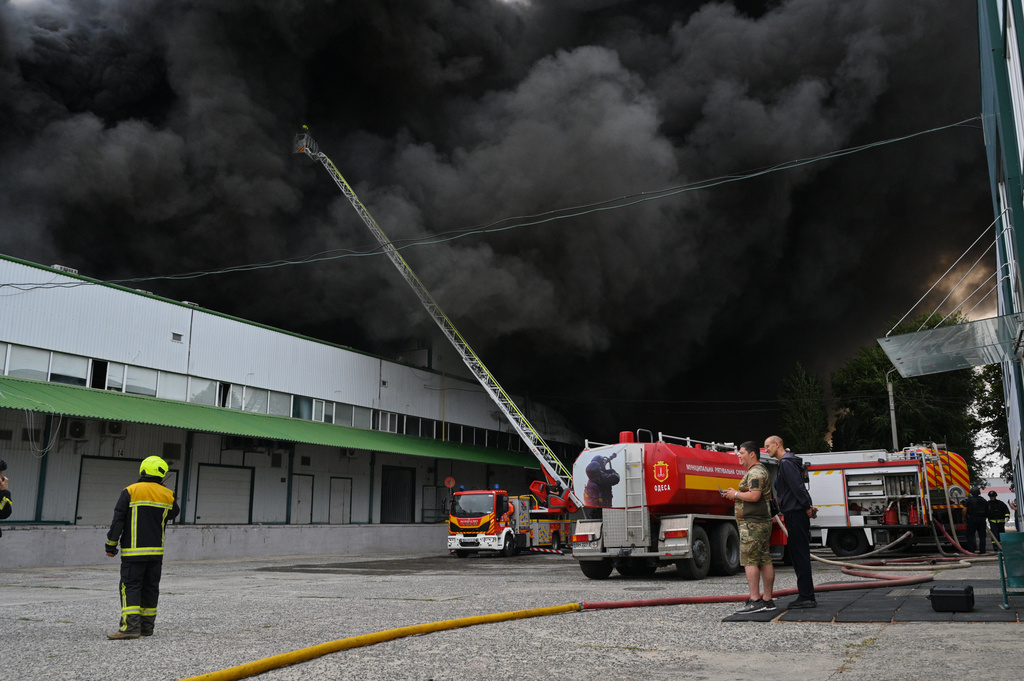 Firefighters put out a fire at warehouse stores after a Russian air attack in Odesa, Ukraine, Sunday, Sept. 13, 2026. (AP Photo/Michael Shtekel)