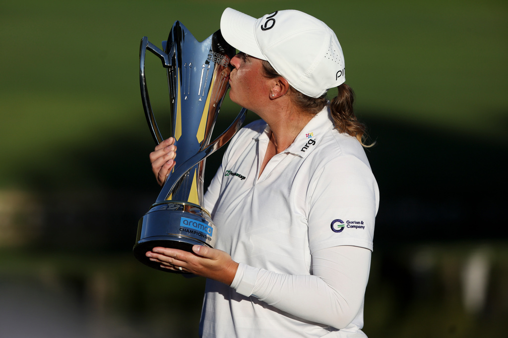 Lauren Coughlin kisses the trophy after winning the Aramco Championship golf tournament Sunday, April 5, 2026, in North Las Vegas, Nev. (AP Photo/Ian Maule)