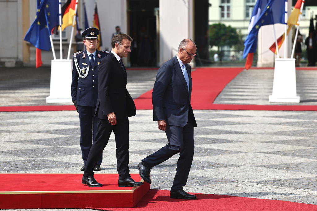 German Chancellor Friedrich Merz, right, welcomes French President Emmanuel Macron with military honors at Augustusburg Palace ahead of a meeting of the Franco-German Ministerial Council in Brühl, Germany, Friday, July 17, 2026. (Oliver Berg/dpa via AP)