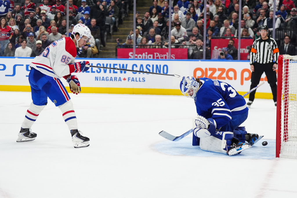 Montréal Canadiens left wing Alexandre Texier (85) scores the winning goal against Toronto Maple Leafs goaltender Dennis Hildeby (35) during shootout NHL hockey game action in Toronto, Saturday, Dec. 6, 2025. (Frank Gunn/The Canadian Press via AP)