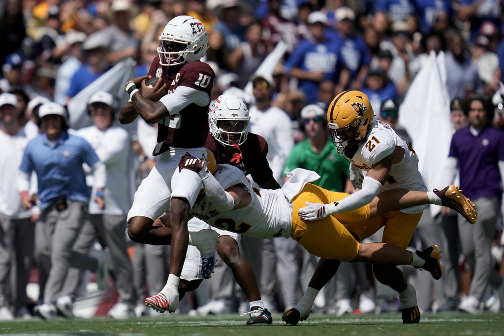 Texas A&M quarterback Marcel Reed (10) is tackeld by Arizona State linebacker Owen Long (22) after a 18 yard scramble during the second quarter of an NCAA college football game Saturday, Sept. 12, 2026, in College Station, Texas. (AP Photo/Sam Craft)