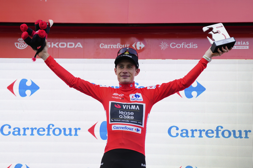 Danish cyclist Jonas Vingegaard celebrates at the podium his first overall position at the end of the nineteenth stage of the Spanish La Vuelta cycling race, from Rueda to Guijuelo, Spain, Friday, Sept. 12, 2025. (AP Photo/Manu Fernandez)