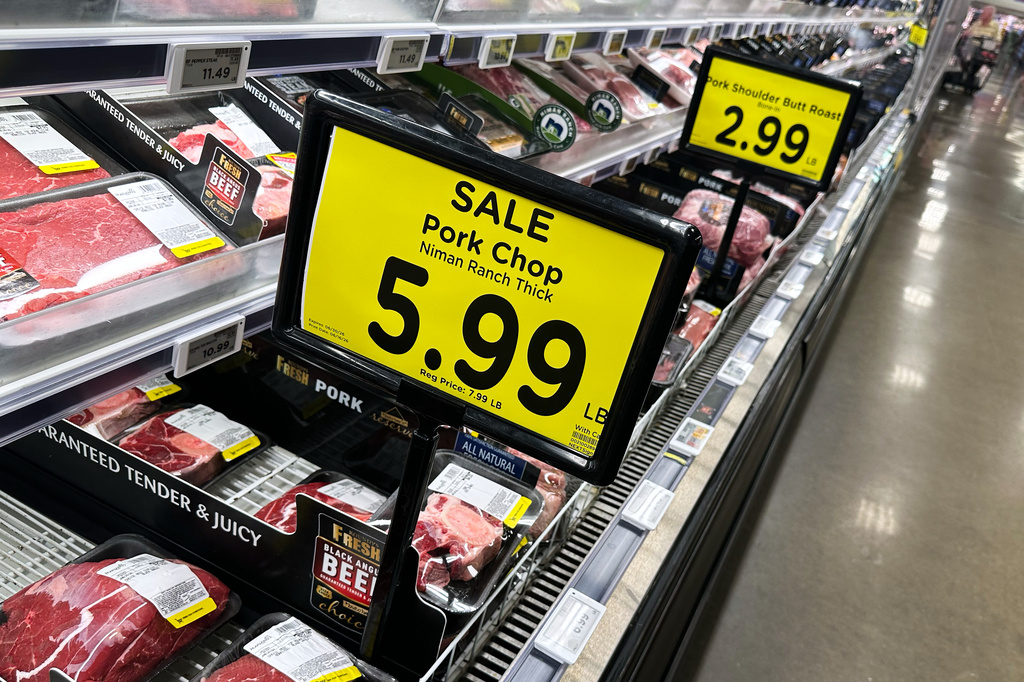 Sale signs of meat are displayed on a refrigerated case inside a grocery store in Chicago, Thursday, June 25, 2026. (AP Photo/Nam Y. Huh)
