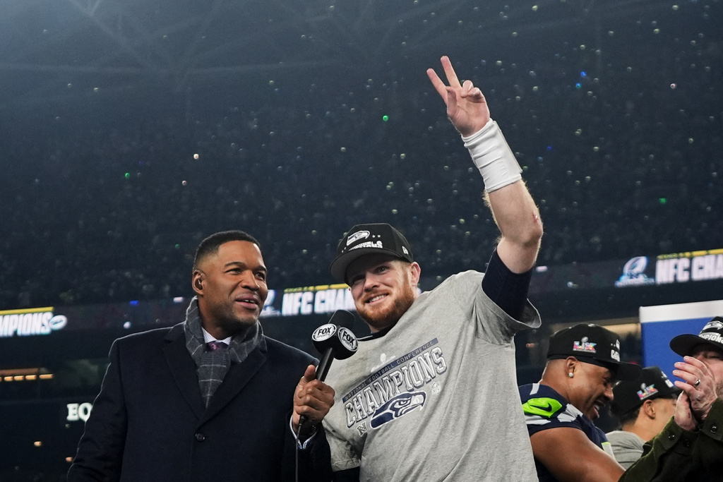 Seattle Seahawks quarterback Sam Darnold, celebrates next to Michael Strahan, left, after a win over the Los Angeles Rams in the NFC Championship NFL football game Sunday, Jan. 25, 2026, in Seattle. (AP Photo/Lindsey Wasson)