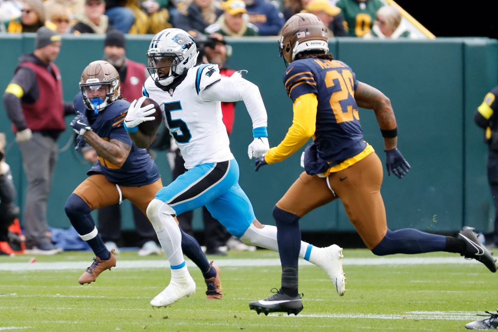 Carolina Panthers running back Rico Dowdle (5) runs against the Green Bay Packers during the first half of an NFL football game Sunday, Nov. 2, 2025, in Green Bay, Wis. (AP Photo/Mike Roemer)