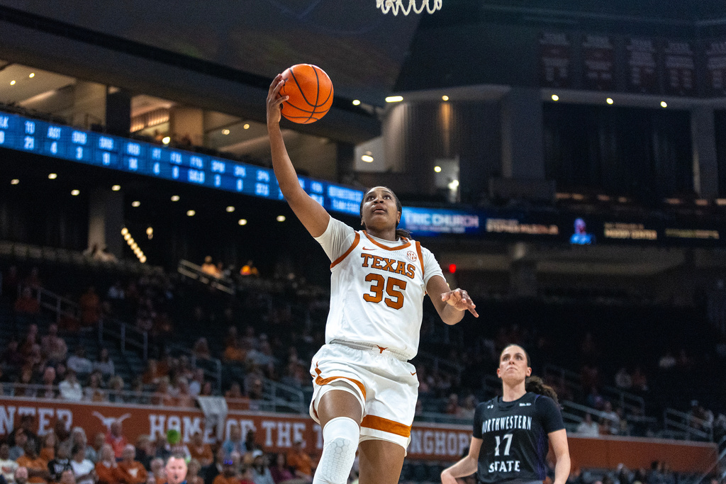 Texas forward Madison Booker goes to the basket over Northwestern State guard Carla Celaya (17) during the second half of an NCAA college basketball game, Wednesday, Dec. 17, 2025, in Austin, Texas. (AP Photo/Stephen Spillman)