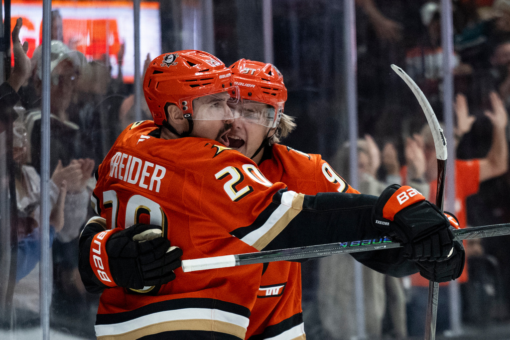 Anaheim Ducks left wing Chris Kreider (20) celebrates his goal with center Leo Carlsson (91) during the first period of an NHL hockey game against the Pittsburgh Penguins, Tuesday, Oct. 14, 2025, in Anaheim, Calif. (AP Photo/Kyusung Gong)