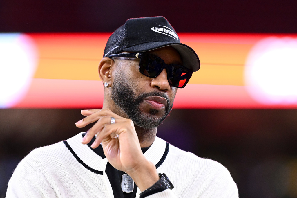 FILE - Basketball Hall of Famer Tracy McGrady stands on the sideline prior an NFL football game between the Houston Texans and the Buffalo Bills, Nov. 20, 2025, in Houston. (AP Photo/Maria Lysaker, File)