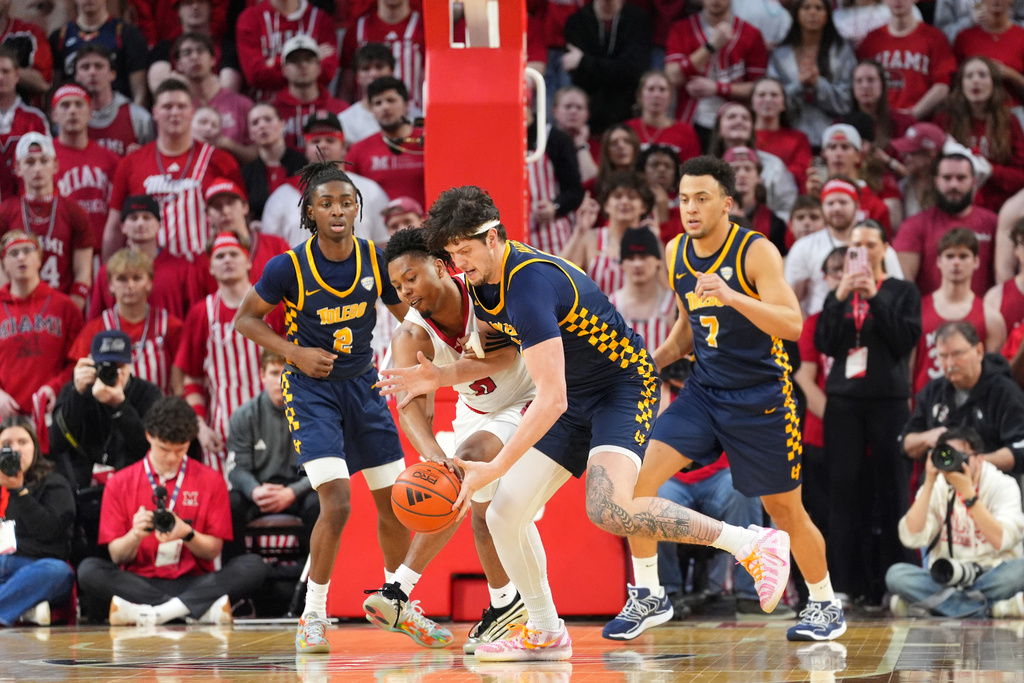 Miami's (OH) Eian Elmer, second from left, and Toledo's Austin Parks, third from left, compete for a loose ball and during the first half of an NCAA college basketball game, Tuesday, March 3, 2026, in Oxford, Ohio. (AP Photo/Kareem Elgazzar)