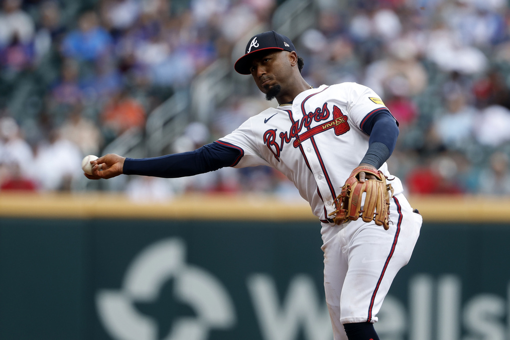 Atlanta Braves second baseman Ozzie Albies throws to first for the out on New York Mets' Luis Torrens during the second inning of a baseball game, Sunday, Aug. 24, 2025, in Atlanta. (AP Photo/Butch Dill)