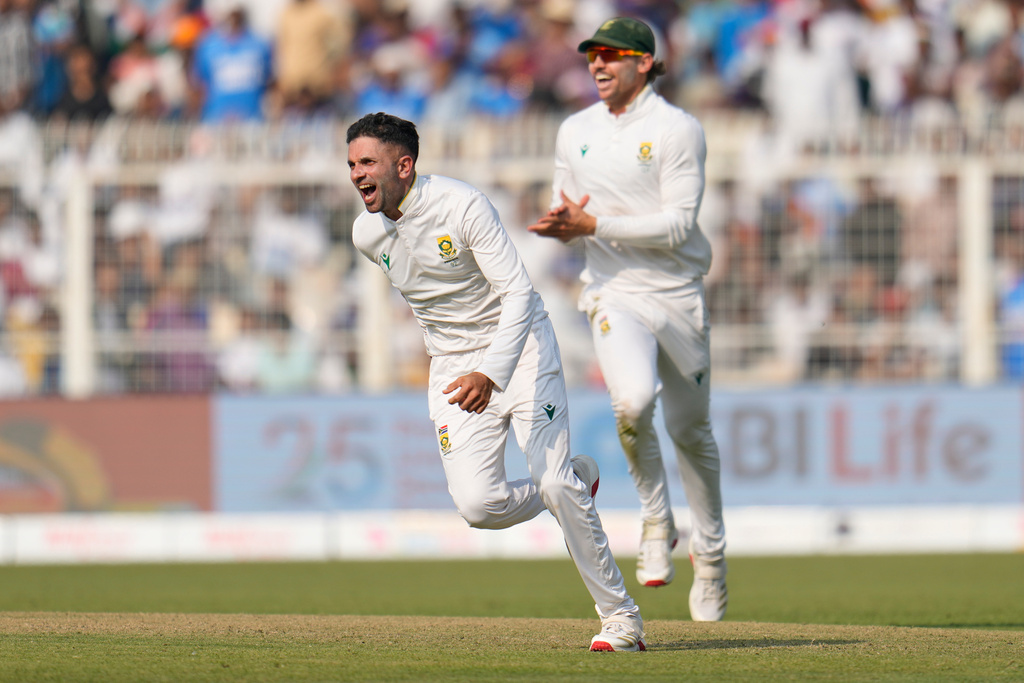 South Africa's Keshav Maharaj, left, celebrates after their win on the third day of the first cricket test match against India in Kolkata, India, Sunday, Nov. 16, 2025. (AP Photo/Aijaz Rahi)