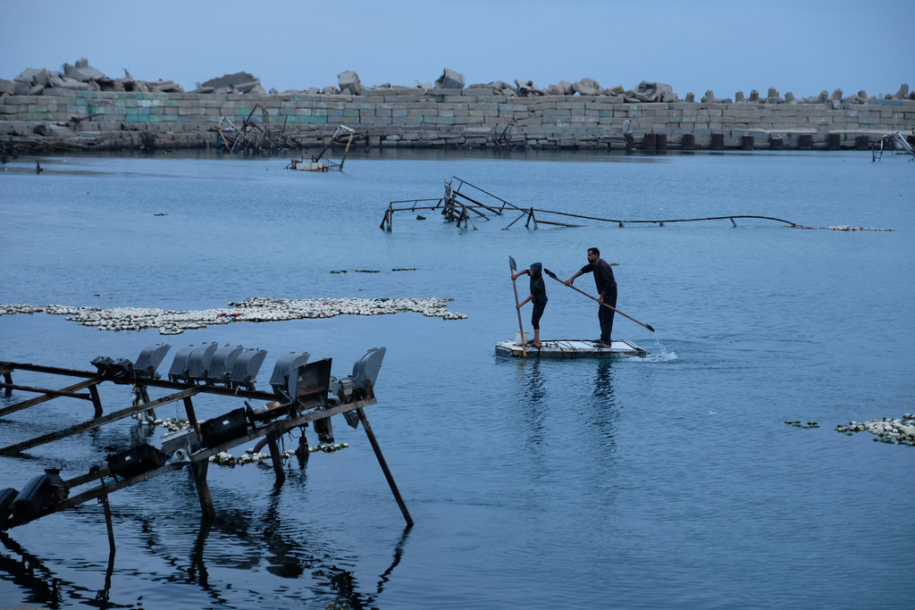 Palestinian fishermen work in the Mediterranean Sea in the port of Gaza City, Saturday, Dec. 6, 2025. (AP Photo/Jehad Alshrafi)