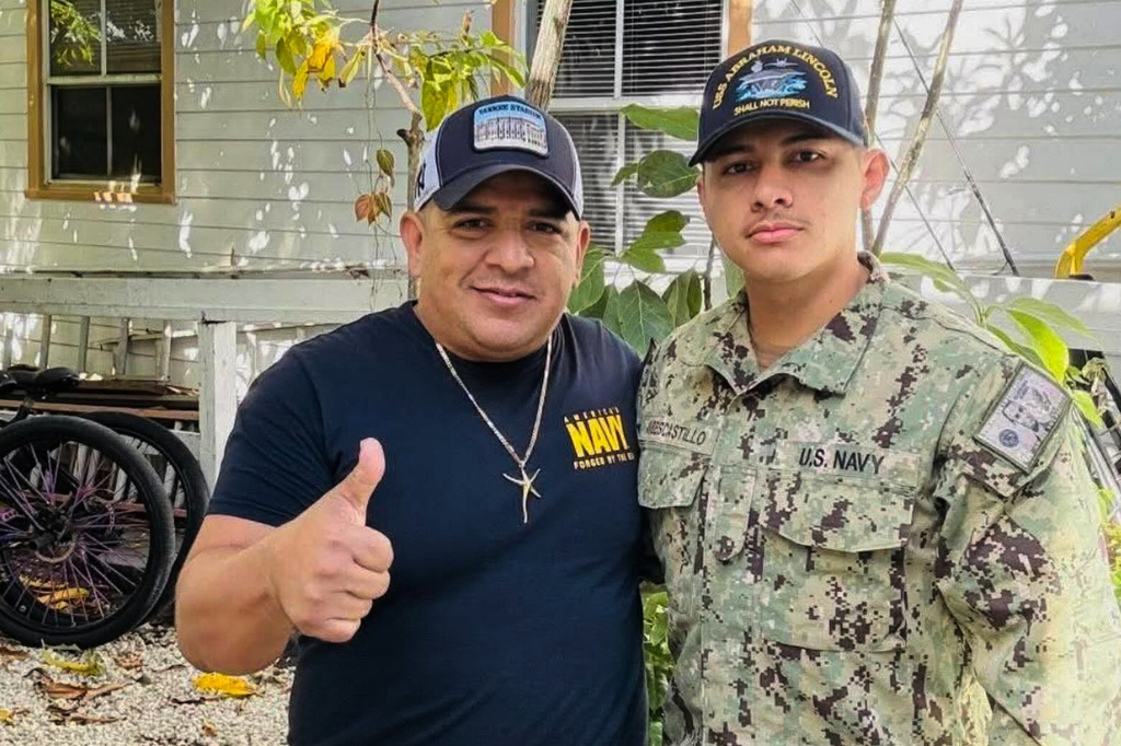 In this photo courtesy of Katherine Delgado shows her step-father Luis Manuel Aviles, left, and her brother Joshua Aviles stand outside their home in Oct. 2025, shortly before Joshua deployed on the USS Lincoln the following month in Key West, Fla. (Katherine Delgado via the AP)