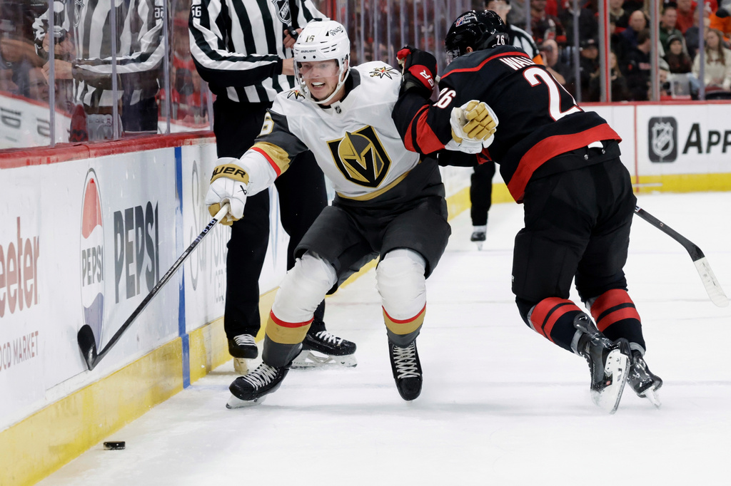 FILE - Vegas Golden Knights right wing Pavel Dorofeyev (16) and Carolina Hurricanes defenseman Sean Walker (26) vie for the puck during the first period of an NHL hockey game Oct. 28, 2025, in Raleigh, N.C. (AP Photo/Chris Seward, File)