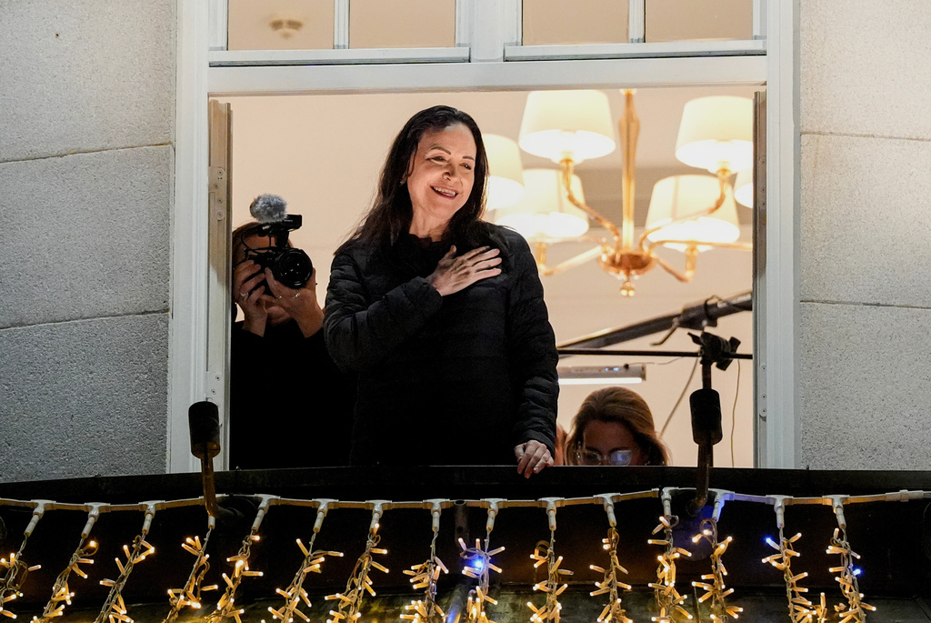 Nobel Peace Prize laureate Maria Corina Machado reacts to the crowd gathered below at the Grand Hotel, in Oslo, Norway, early Thursday, Dec. 11, 2025. (Lise Åserud/NTB Scanpix via AP)