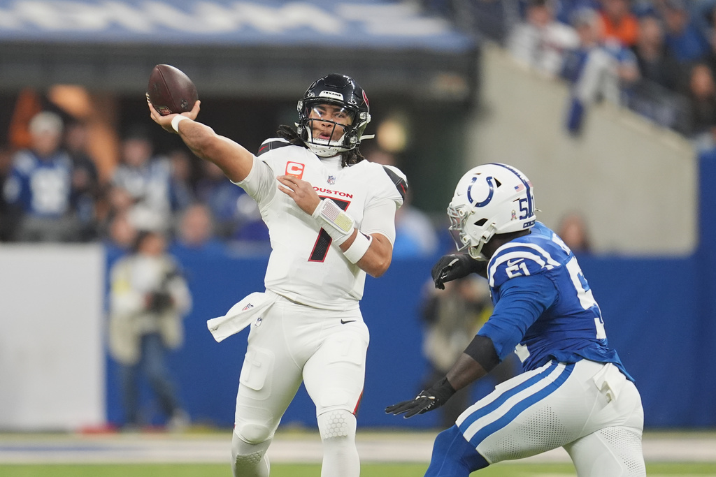 Houston Texans quarterback C.J. Stroud (7) throws a pass as Indianapolis Colts defensive end Kwity Paye (51) defends during the first half of an NFL football game Sunday, Nov. 30, 2025, in Indianapolis. (AP Photo/Michael Conroy)