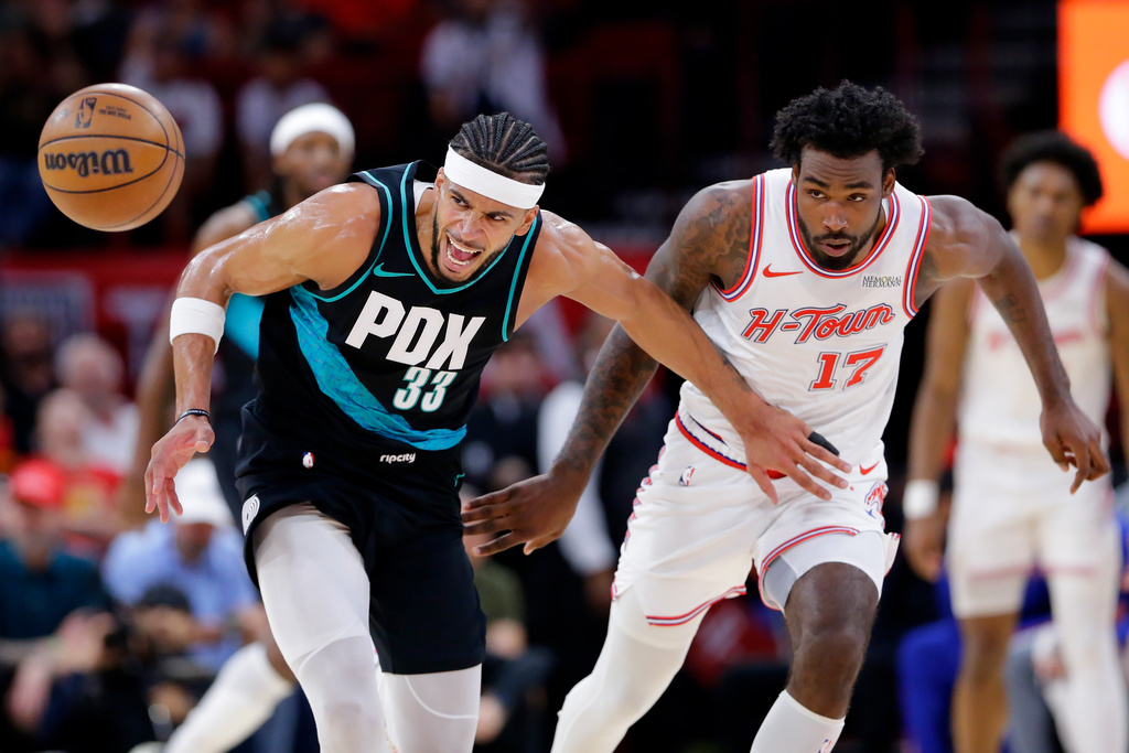 Portland Trail Blazers forward Toumani Camara (33) loses the ball while under pressure from Houston Rockets forward Tari Eason (17) during the first half of an NBA basketball game Friday March 6, 2026, in Houston. (AP Photo/Michael Wyke)