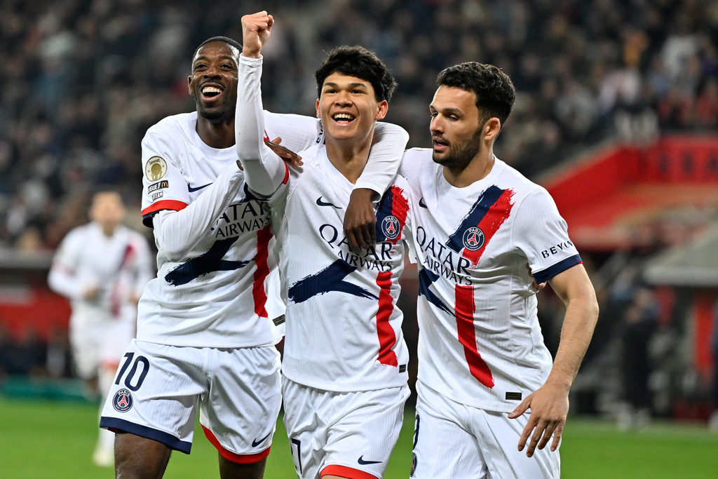 PSG's Pedro Fernandez, center, celebrates after scoring his side's third goal during the French League One soccer match between Nice and Paris Saint-Germain in Nice, France, Saturday, March 21, 2026. (AP Photo/Philippe Magoni)