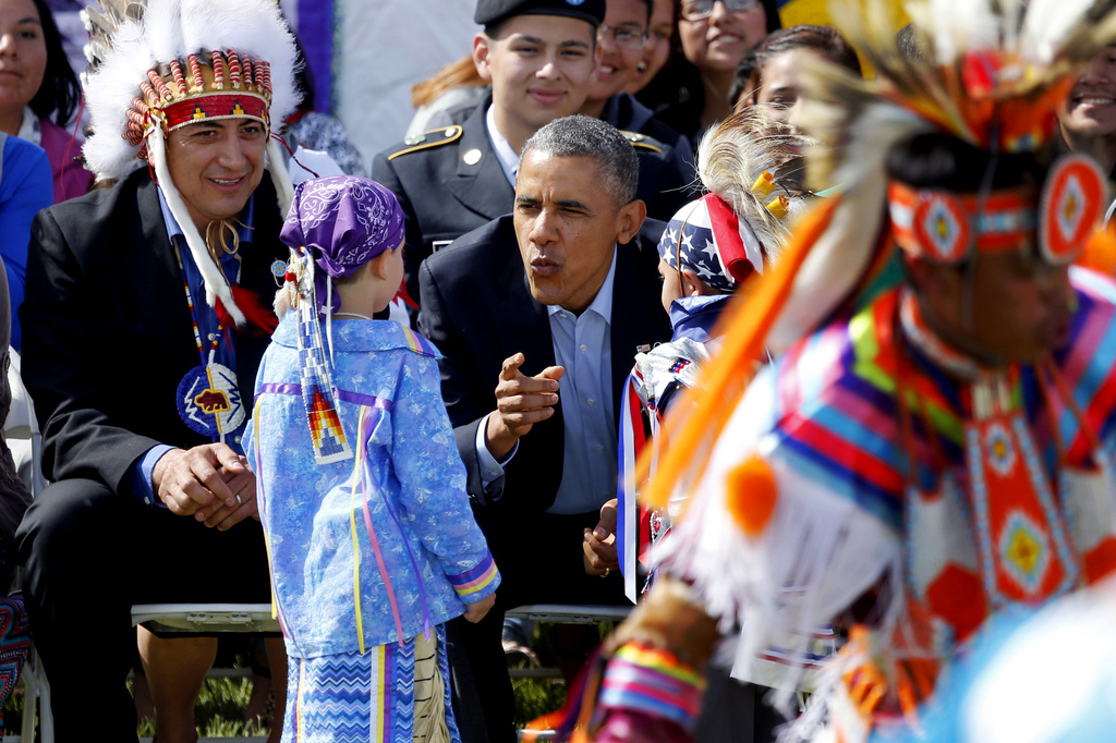 FILE - President Barack Obama talks to two young boys during a Native American dance on the Standing Rock Indian Reservation Friday, June 13, 2014, photo in Cannon Ball, N.D. (AP Photo/Charles Rex Arbogast,File)