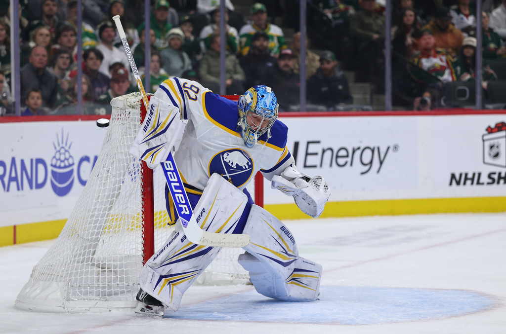 Buffalo Sabres goaltender Colten Ellis (92) deflects the shot against theMinnesota Wild during the first period of an NHL hockey game Saturday, Nov. 29, 2025, in St. Paul, Minn. (AP Photo/Adam Bettcher)
