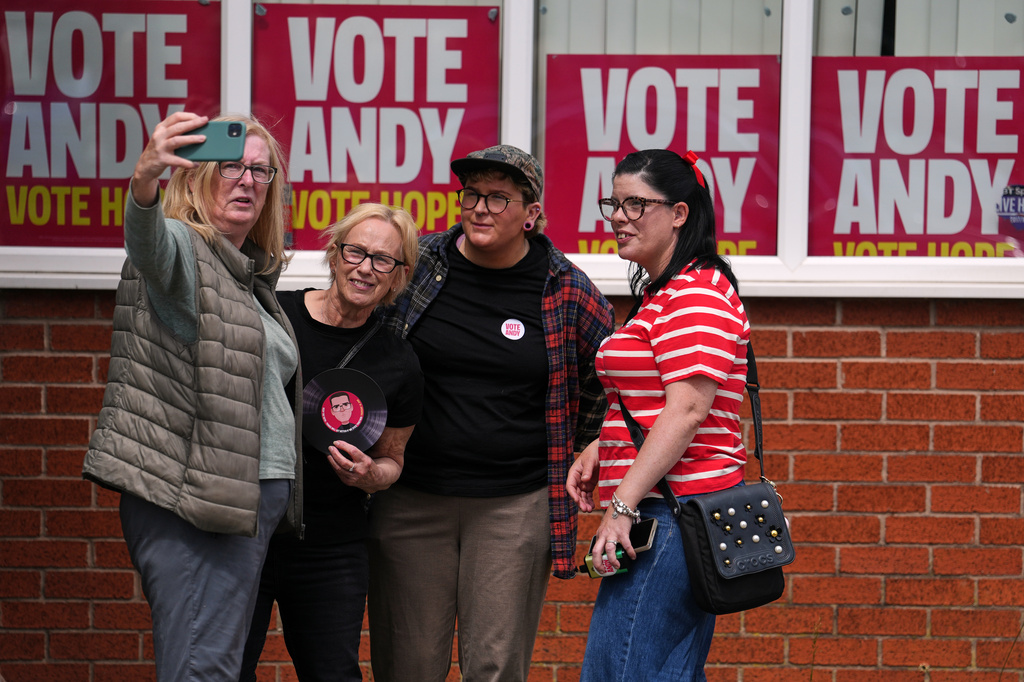 Labour Party campaigners take a selfie at their headquarters during the by-election in Makerfield, England, Thursday, June 18, 2026 where voters are choosing a new lawmaker with Andy Burnham of the Labour Party as the leading contender.(AP Photo/Jon Super)