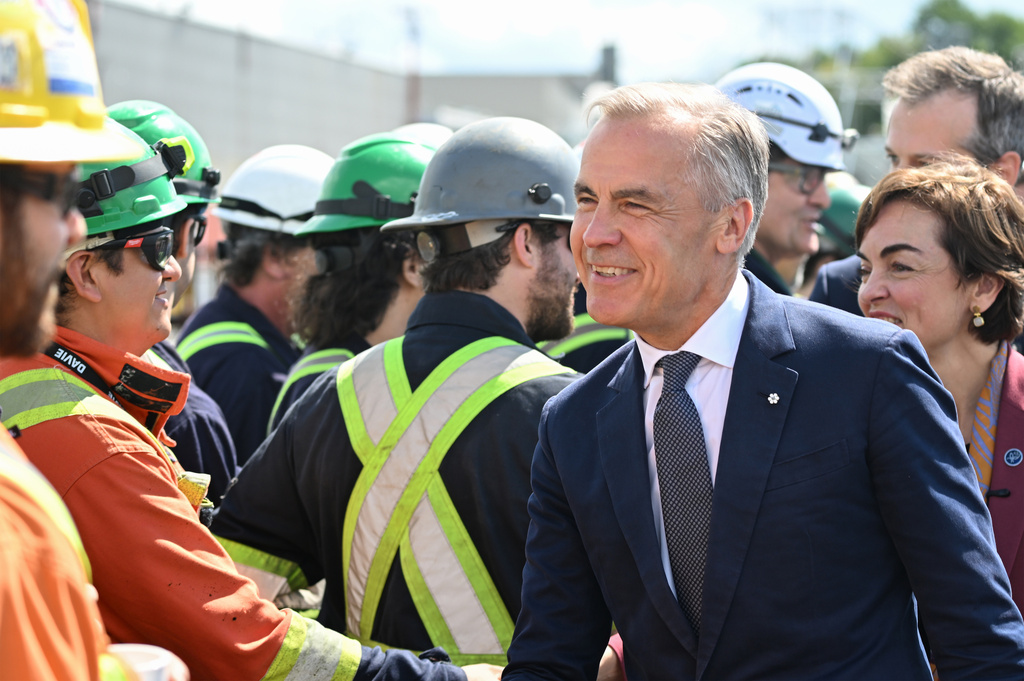 Canadian Prime Minister Mark Carney meets workers at the Davie shipyard in Levis, Monday, Aug. 24, 2026. (Jacques Boissinot/The Canadian Press via AP)