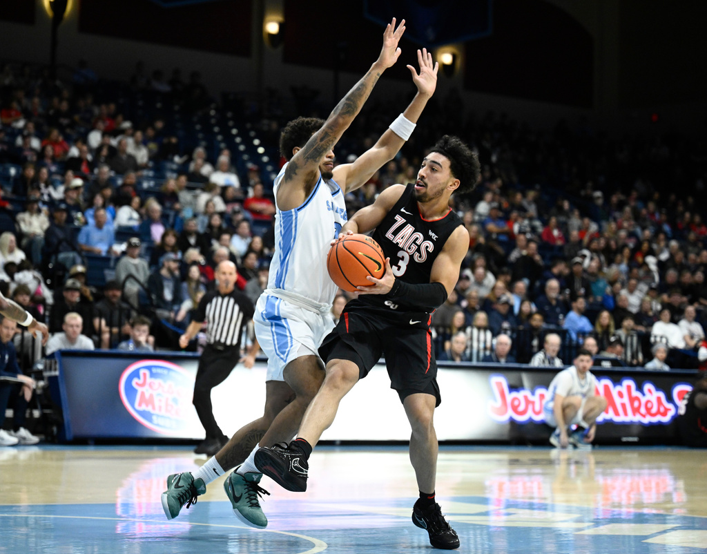 San Diego guard Adrian McIntyre (2) defends against Gonzaga guard Braeden Smith (3) during the first half of an NCAA college basketball game Tuesday, Dec. 30, 2025, in San Diego. (AP Photo/Denis Poroy)