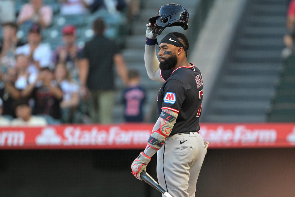 Cleveland Guardians' Jo Adell tips his batting helmet to fans during an at-bat in the first inning of a baseball game against the Los Angeles Angels, Monday, Aug. 24, 2026, in Anaheim, Calif. (AP Photo/Jayne Kamin-Oncea)