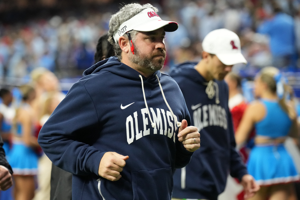 Mississippi head coach Pete Golding runs on the field at halftime during the Sugar Bowl NCAA college football playoff quarterfinal game against Georgia, Thursday, Jan. 1, 2026, in New Orleans. (AP Photo/Matthew Hinton)